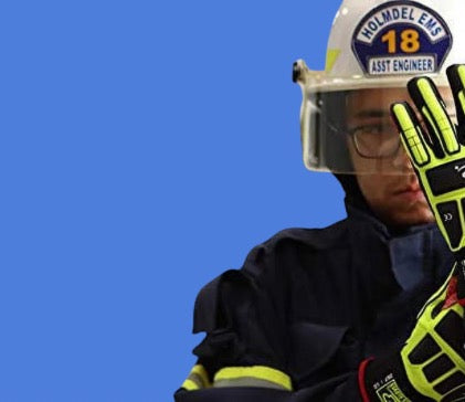 Blue Background with firefighter in gear putting on Ansell Ringer Gloves